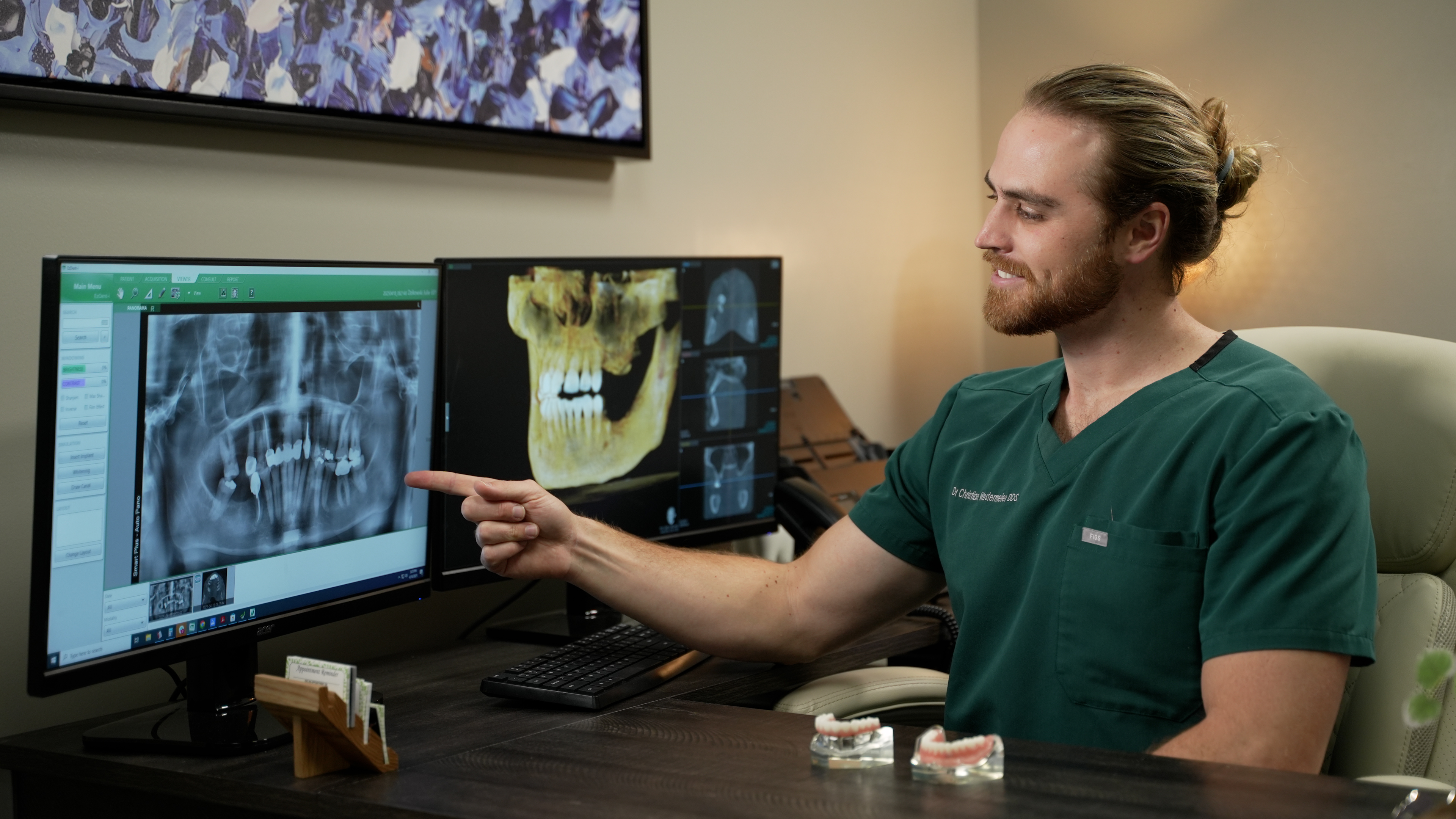 A Wellness Dental doctor reviews a panoramic X-ray with a patient
